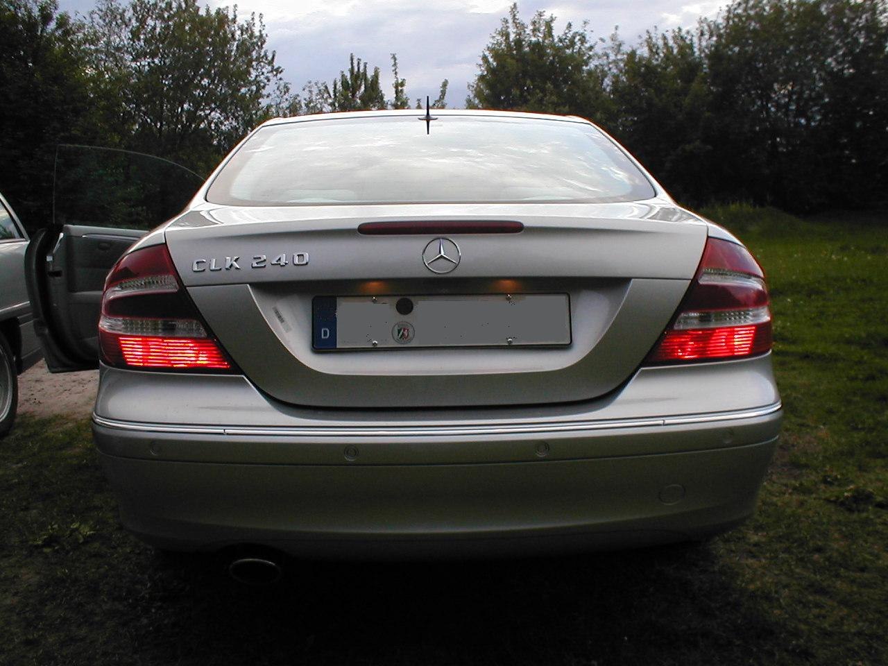 Rear view with illuminated tail lights and trunk design