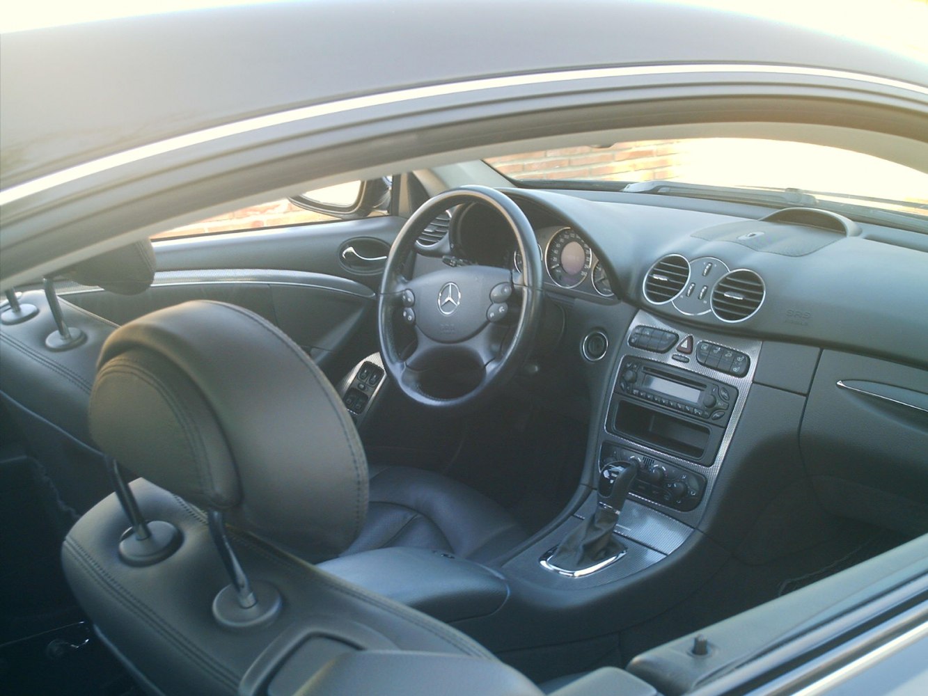 Luxurious steering wheel, dashboard, and interior center console with automatic gear lever