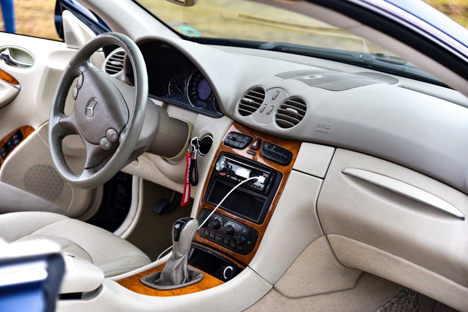 Luxury car interior with wood trim dashboard and detailed central controls