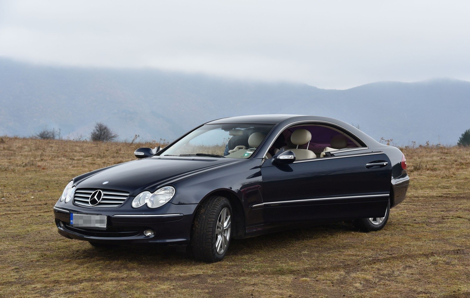 Two-door coupe with dual circular headlights and alloy wheels