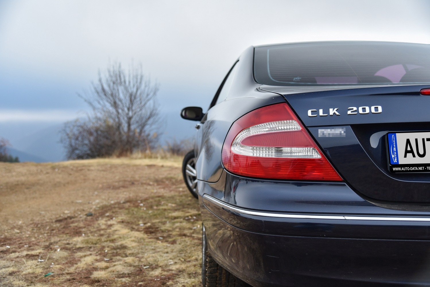 Close-up of rear tail light and badge on a vehicle's rear end