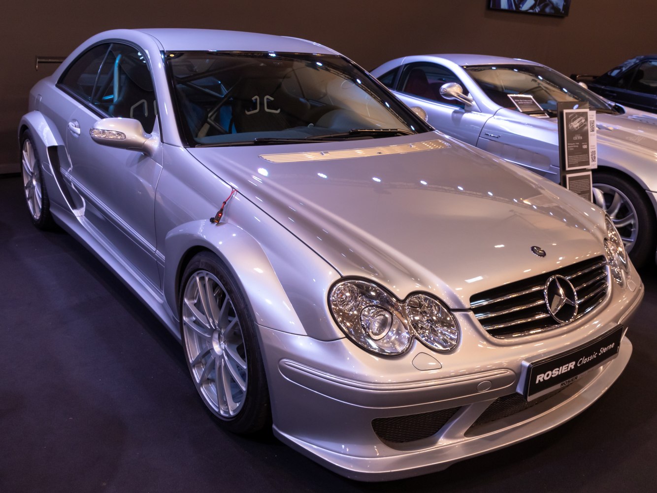 Front view of a modified silver coupe with racing styling and aerodynamic enhancements