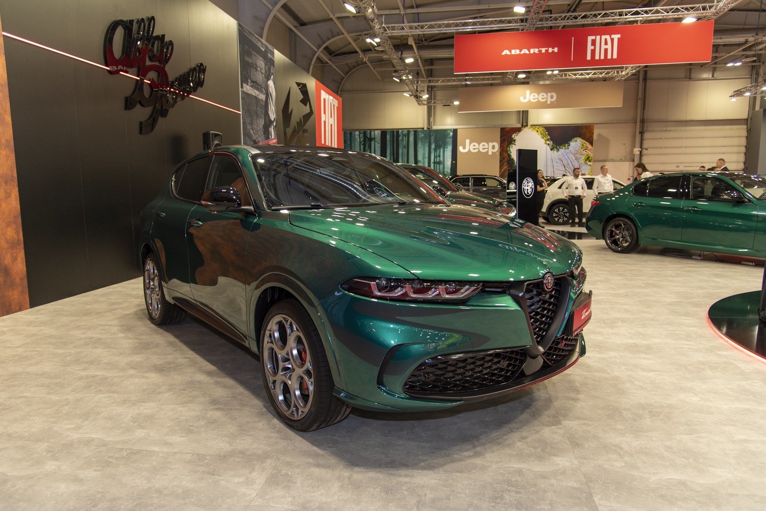 Front view with triangular grille and LED headlights on sleek green SUV