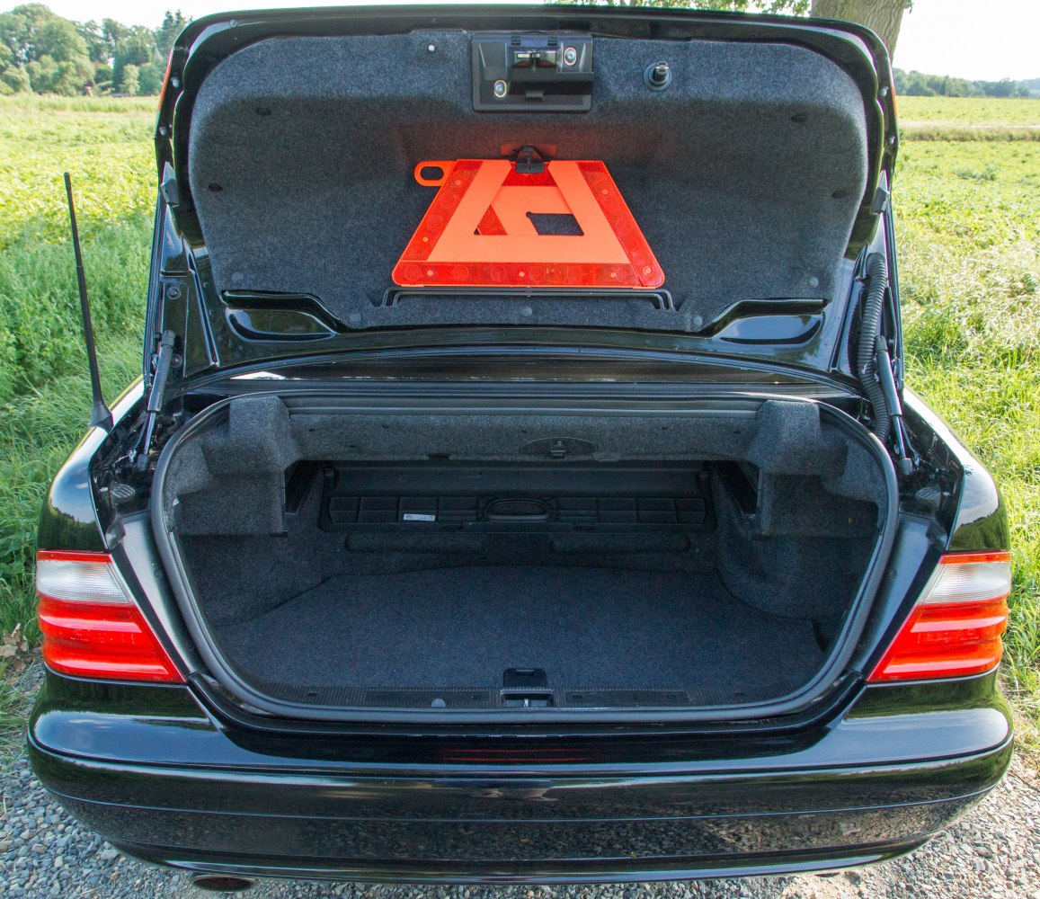 Rear trunk interior with warning triangle and safety latch