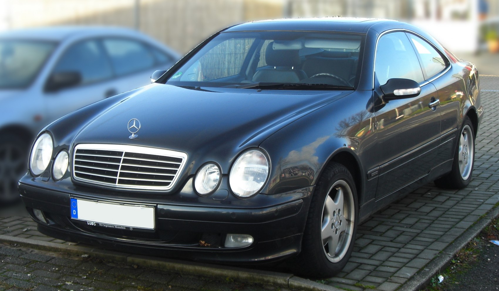 Front grille and dual round headlights of a luxury coupe