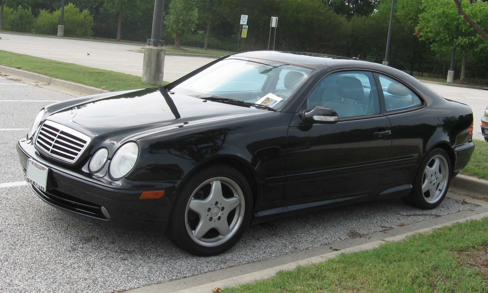 Black coupe with round headlights and 5-spoke alloy wheels