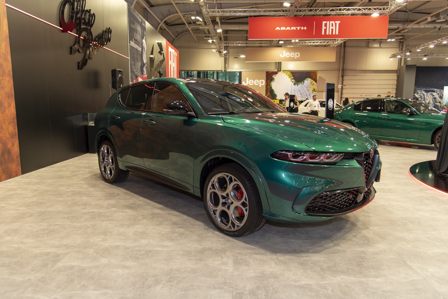 Front view and alloy wheels of a green SUV.