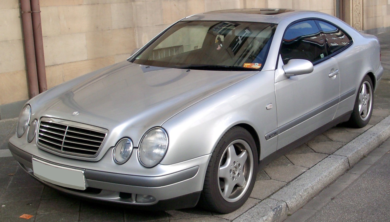 Silver coupe with round headlights and five-spoke wheels