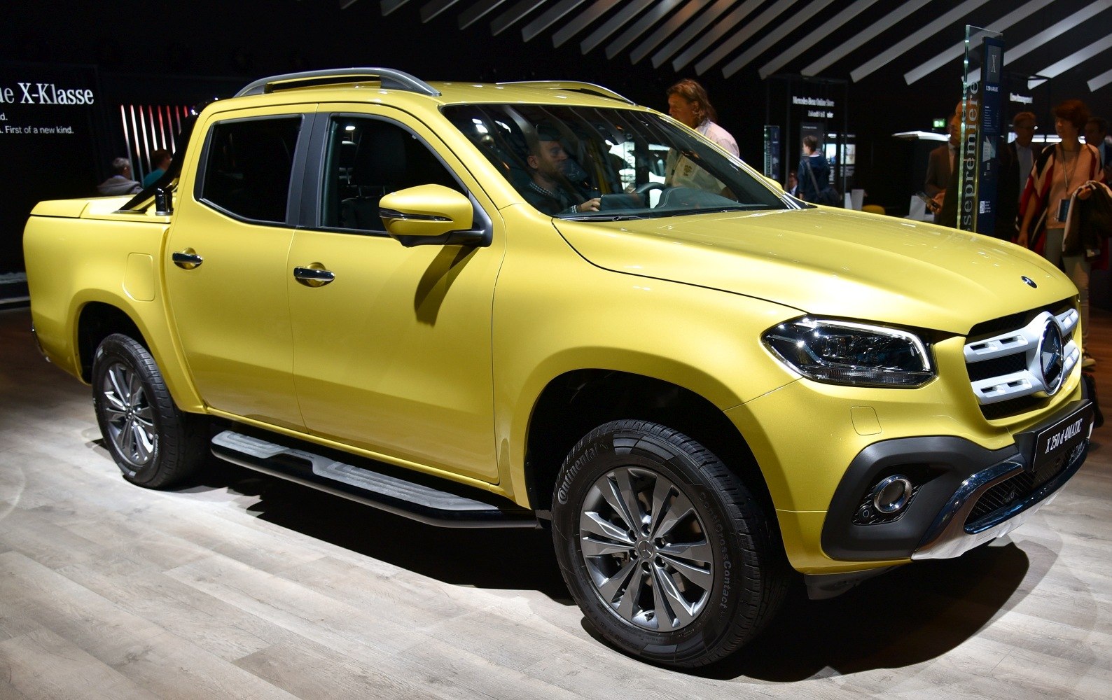 Double cab pickup with alloy wheels, roof rails, and side steps