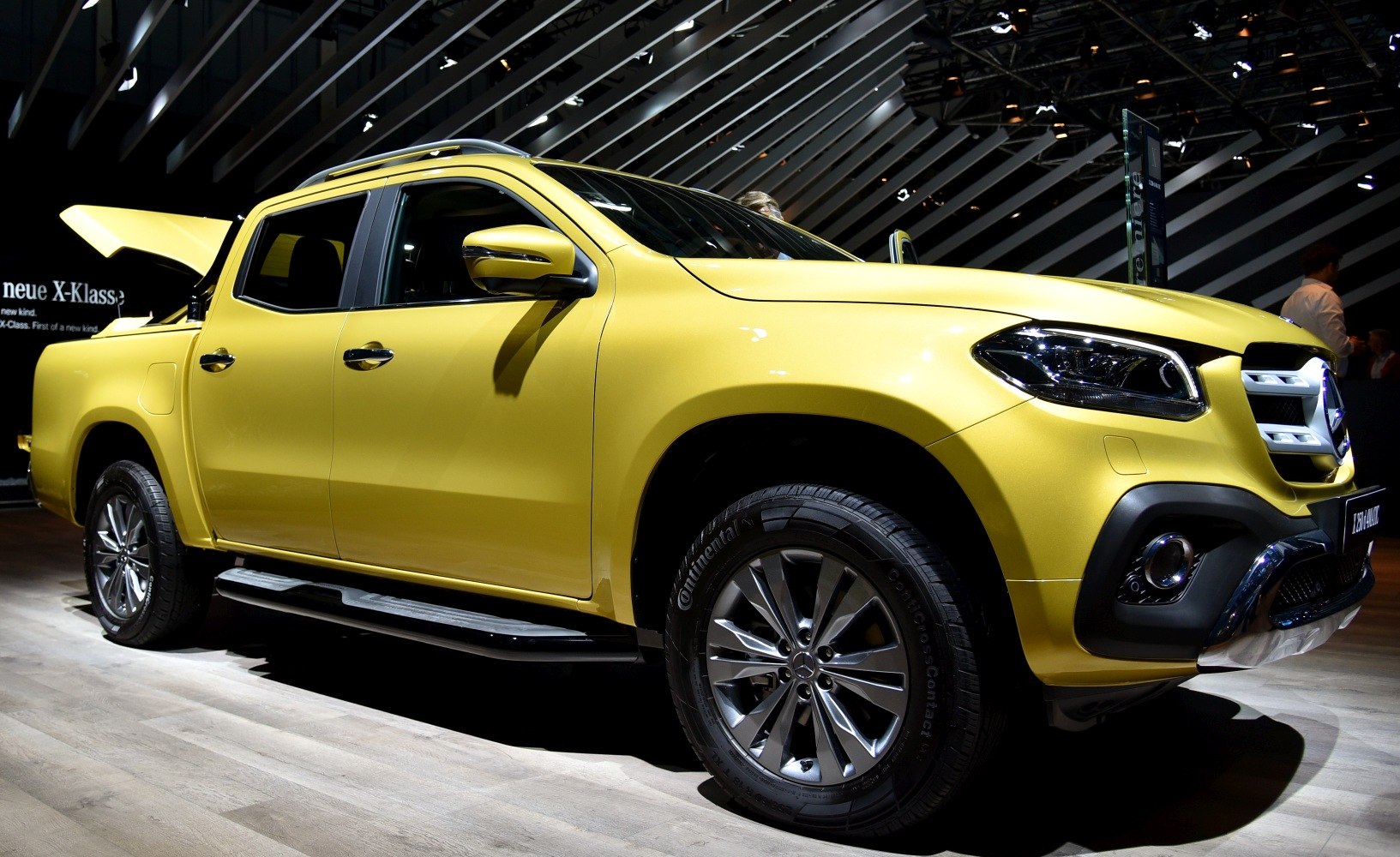 Yellow pickup truck front side with alloy wheels and modern headlights