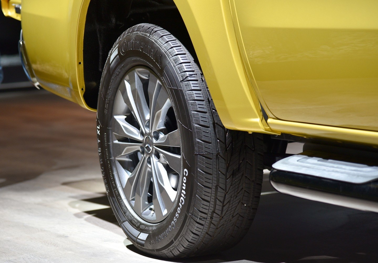 Close-up of alloy wheel and Continental tire on pickup truck.