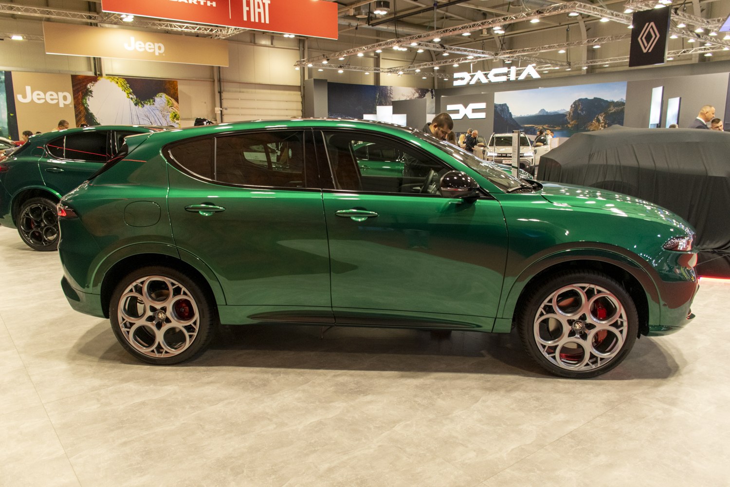 Side profile of a compact SUV with unique circular alloy wheels.