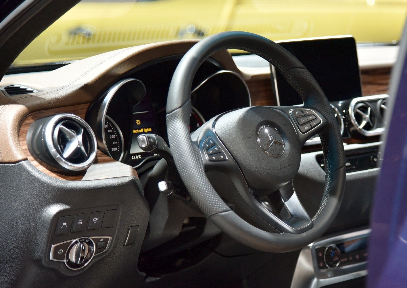Steering wheel and dashboard with control buttons and air vents