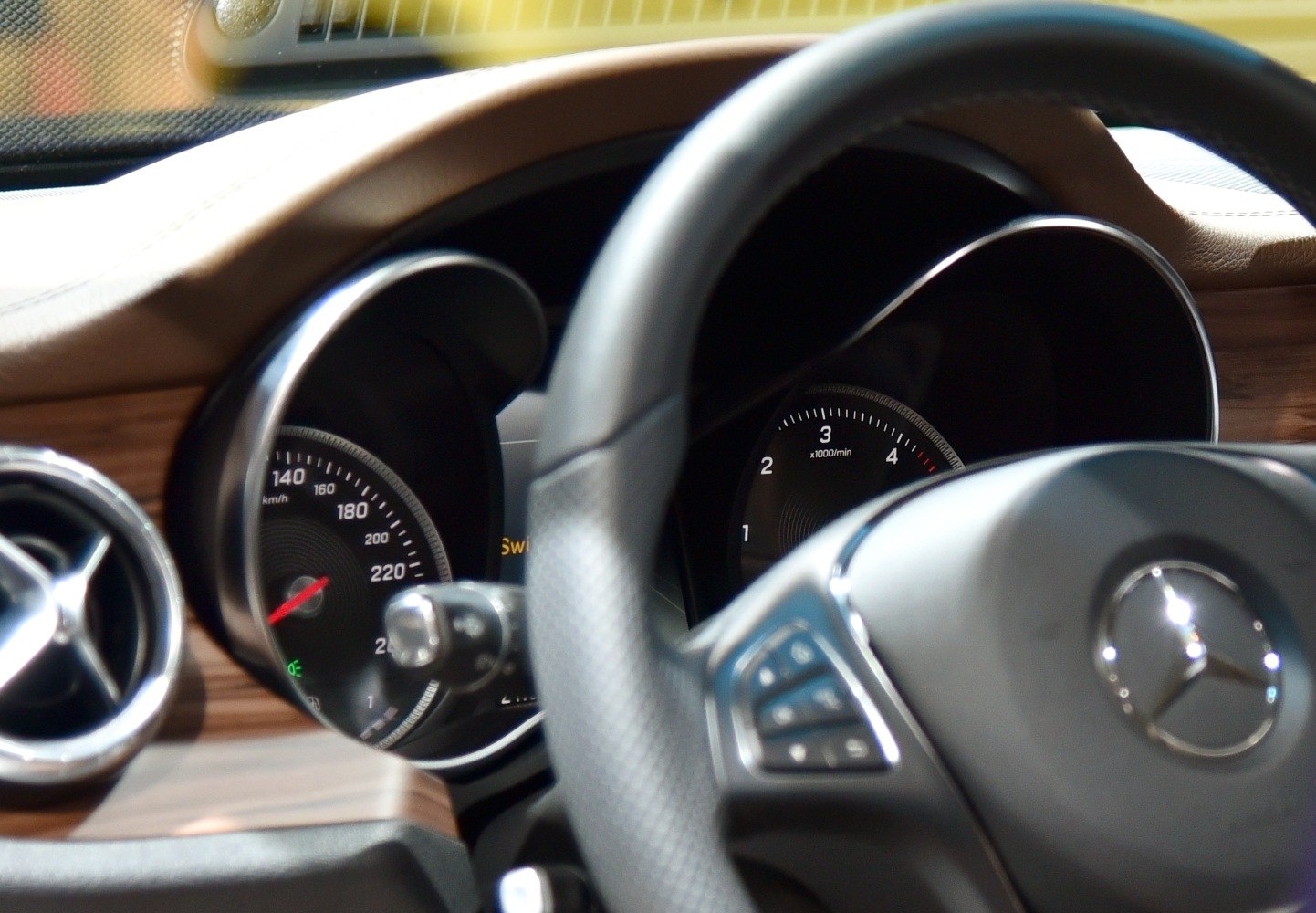 Dashboard instruments and steering wheel with wood trim interior