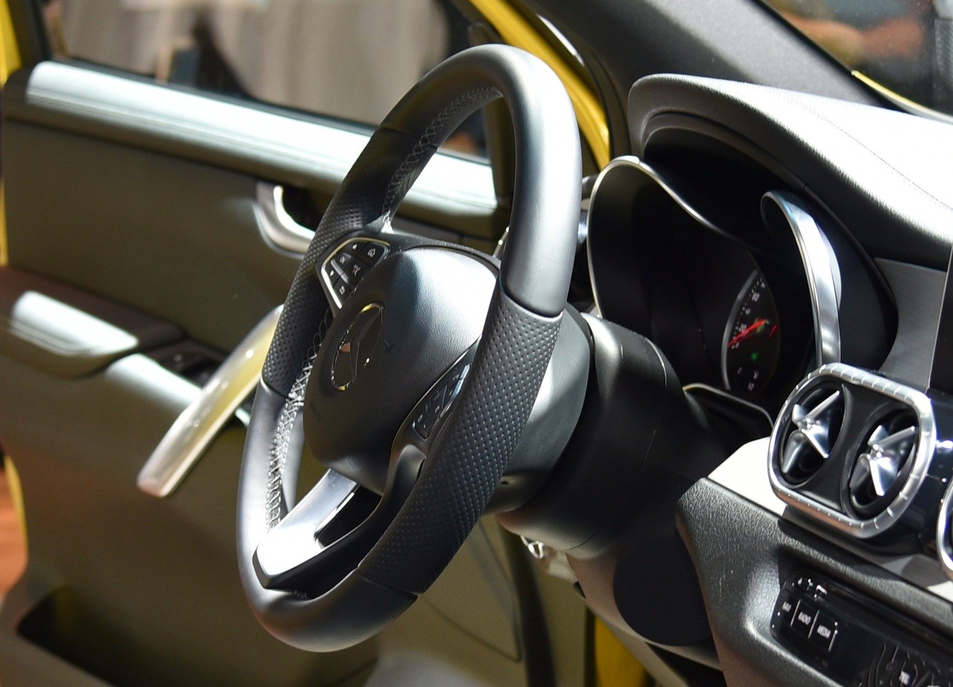 Close-up of steering wheel and dashboard air vents in vehicle interior