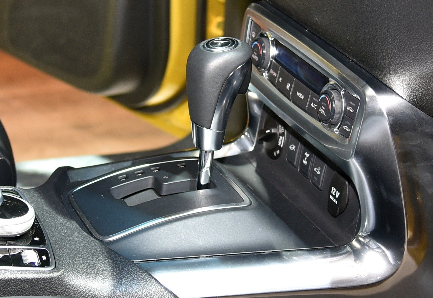 Automatic gear shift lever and center console controls in a vehicle interior