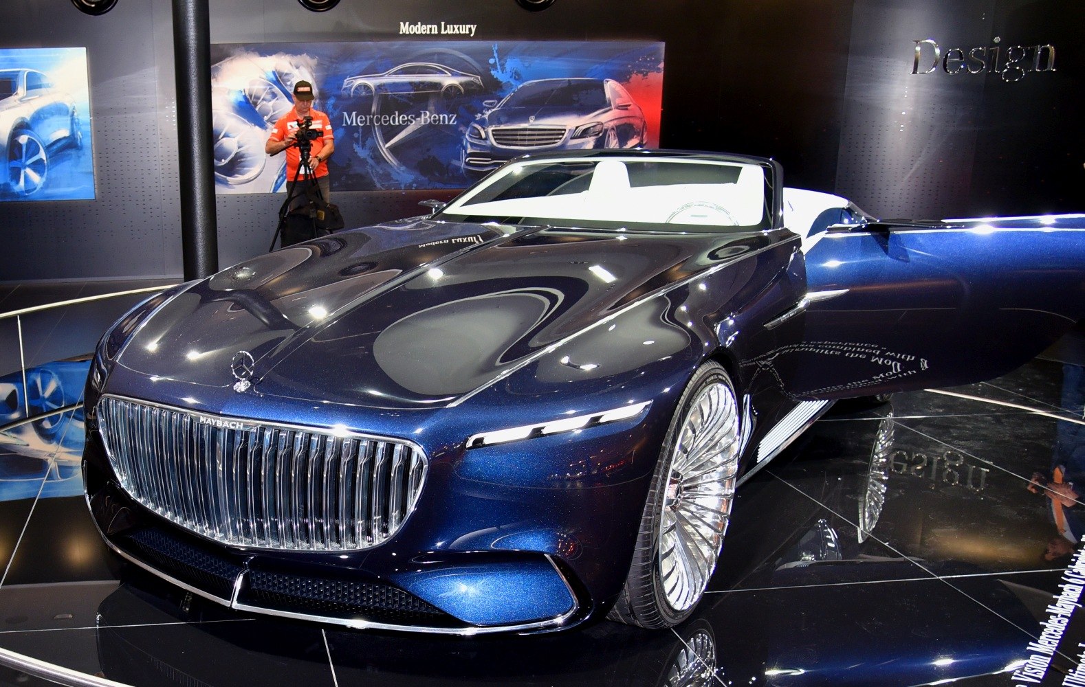 Luxury convertible with prominent chrome grille and aerodynamic body.