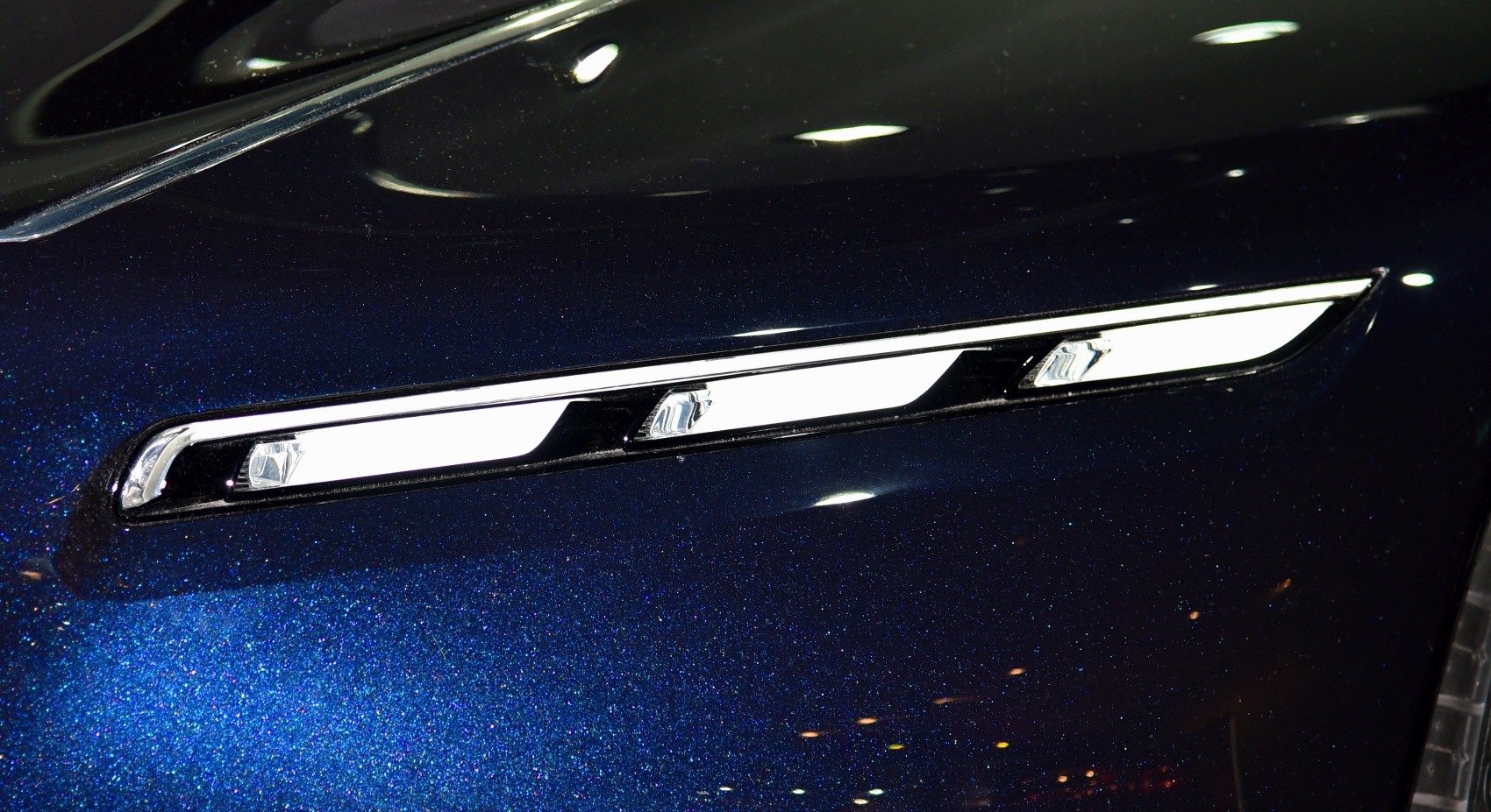 Sleek LED headlight strip with chrome detailing.