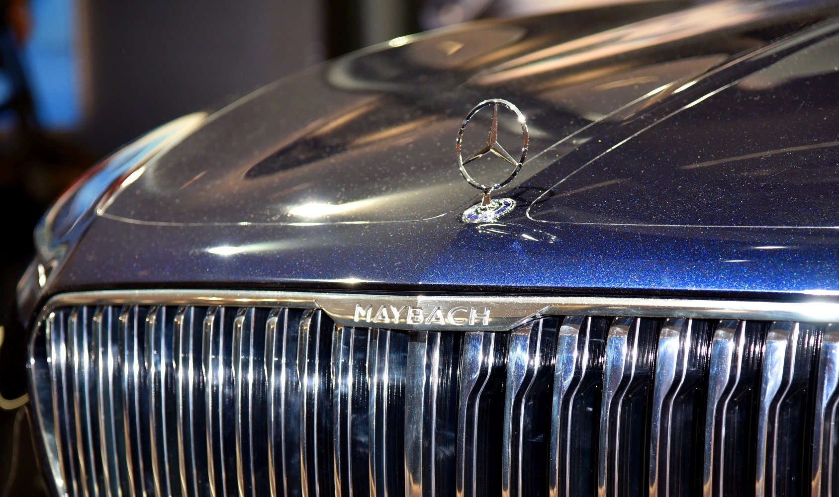 Vertical slat grille and Mercedes hood ornament on car front