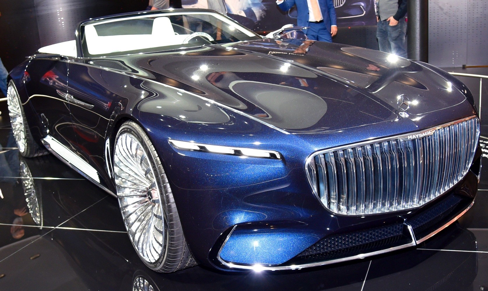 Front end with large vertical grille and slim LED headlights on a luxury convertible.