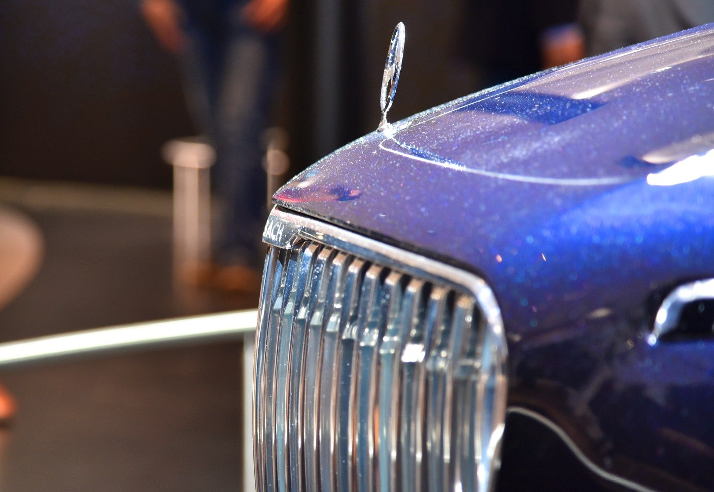 Luxury hood ornament and vertical chrome grille close-up