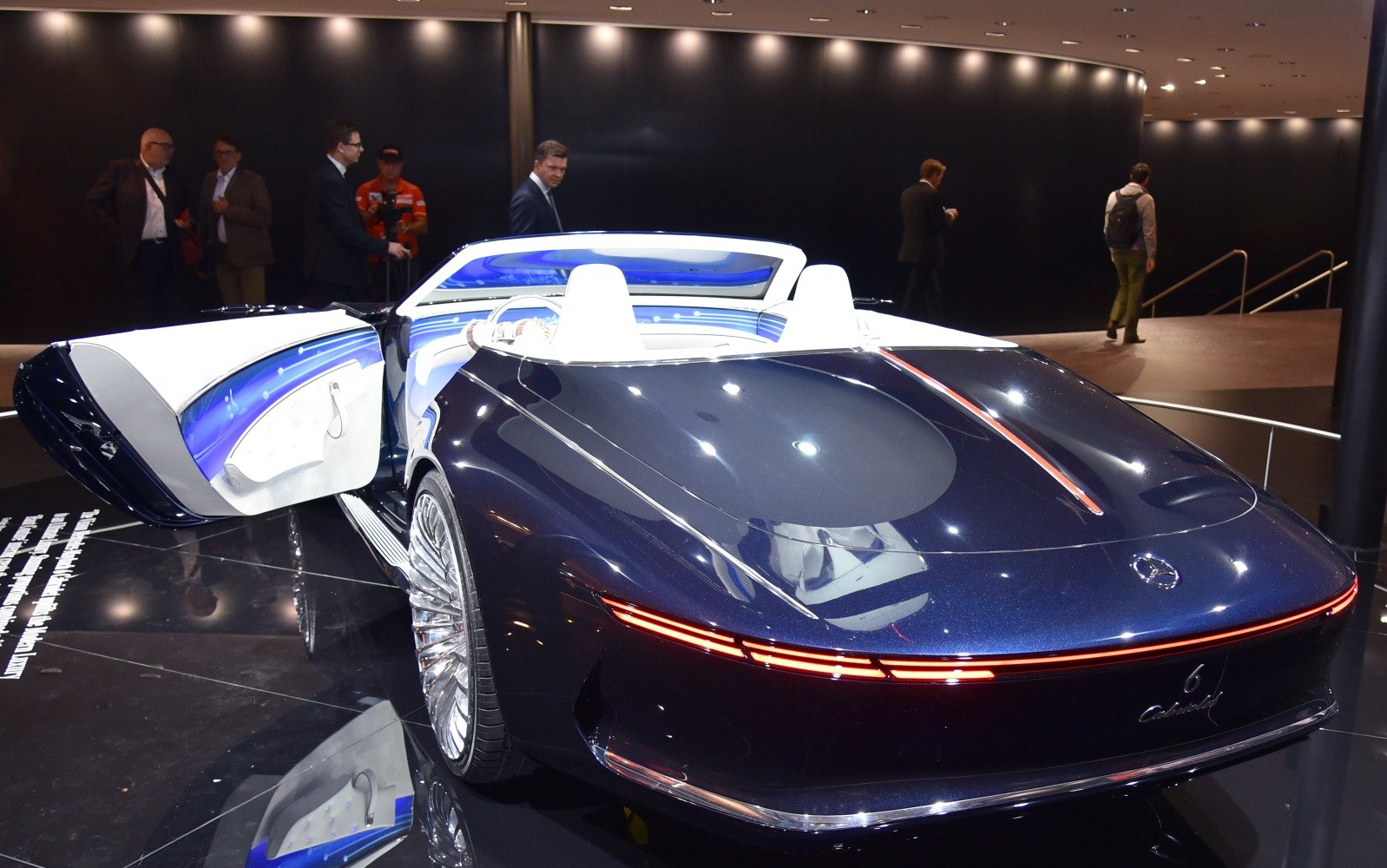 Rear view of luxury convertible with open door and illuminated interior