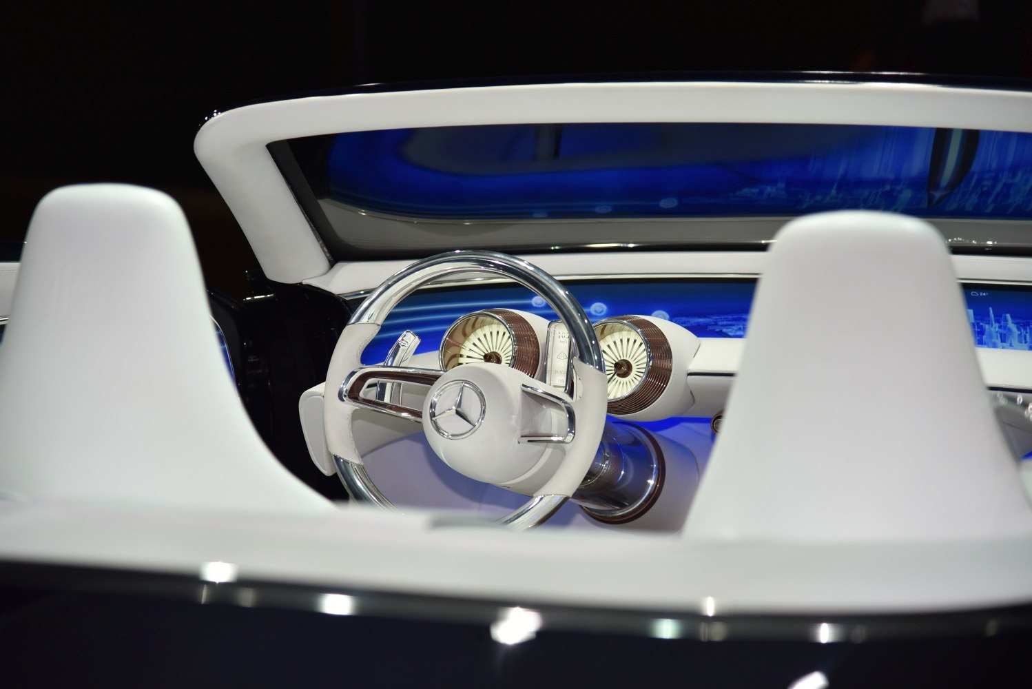 Futuristic steering wheel and dual circular instrument gauges with blue dashboard lighting