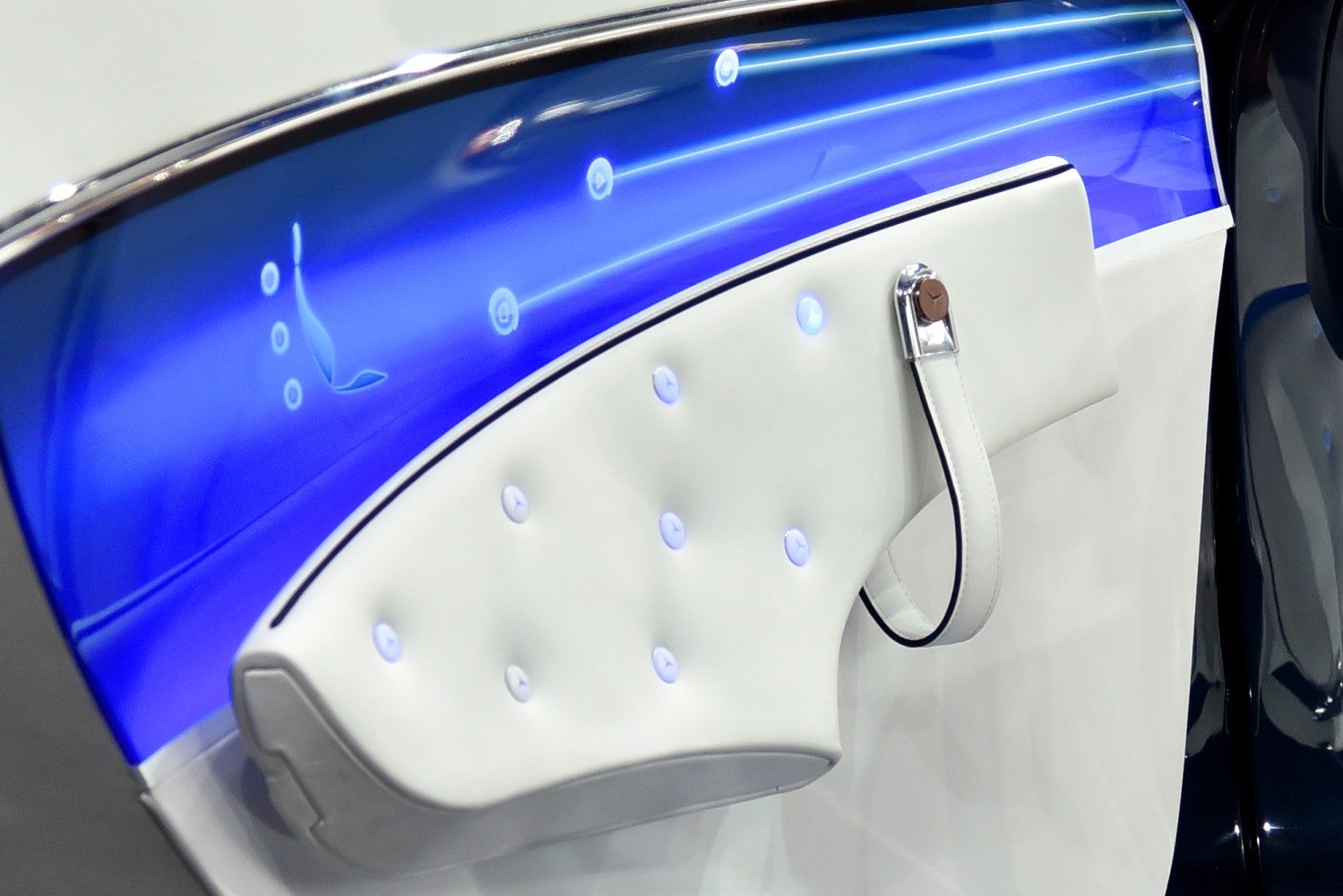 Illuminated blue door panel with white leather and embedded lighted buttons