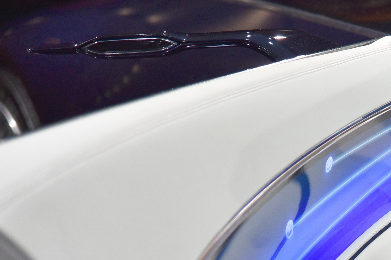 Futuristic side mirror with white leather interior and blue ambient lighting
