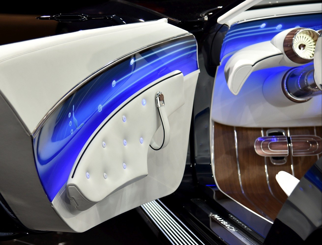 Luxury car interior door with blue ambient lighting and wood trim