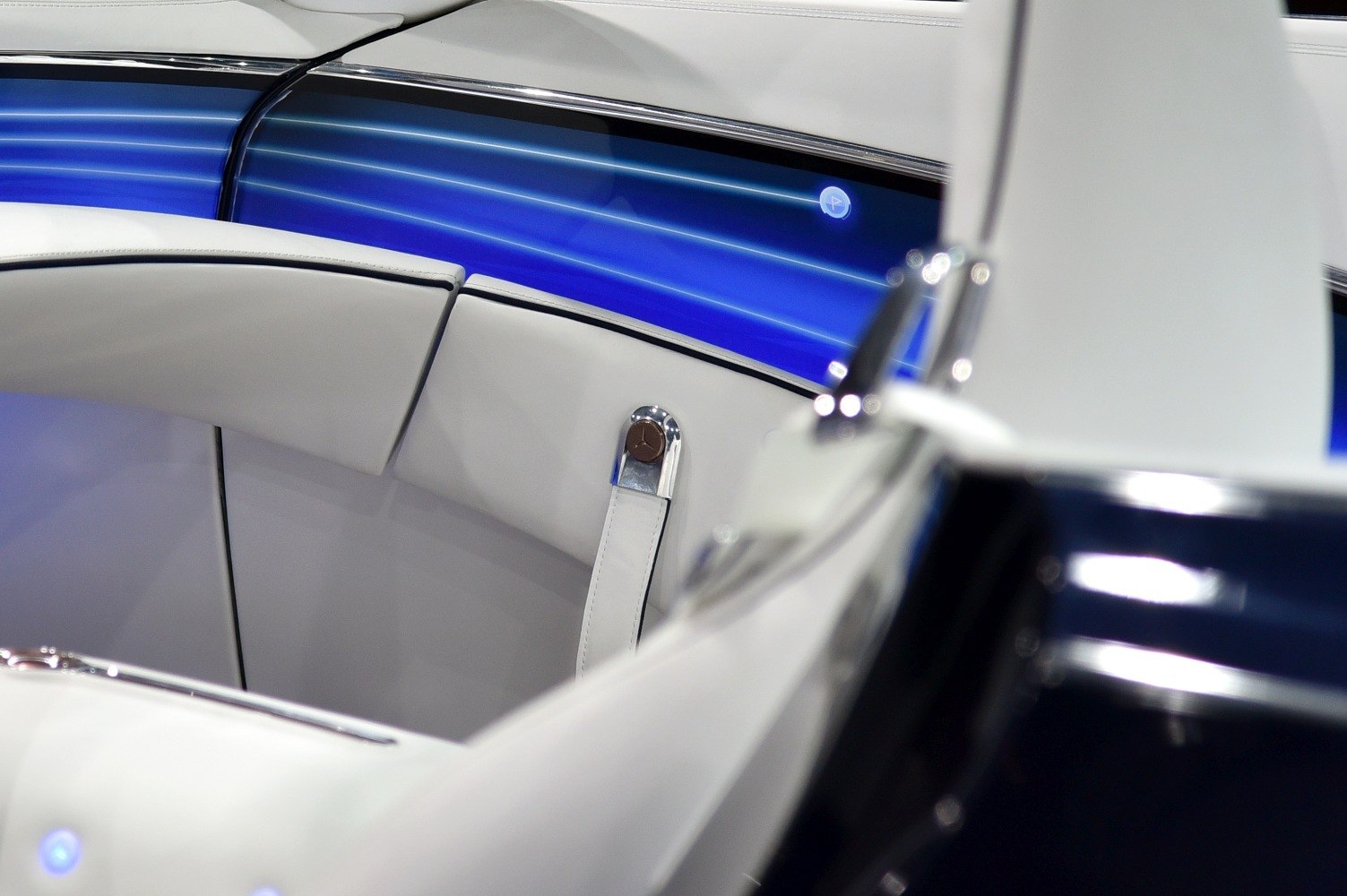 White leather seats with ambient blue lighting inside luxury car
