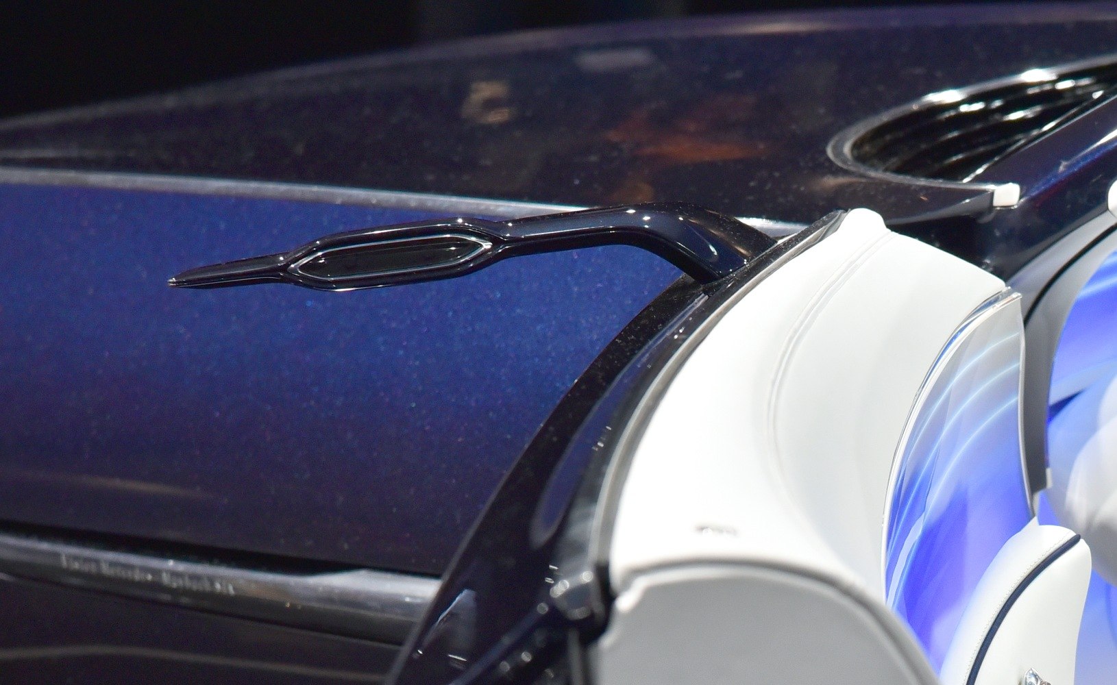 Sleek exterior side mirror with white leather interior trim