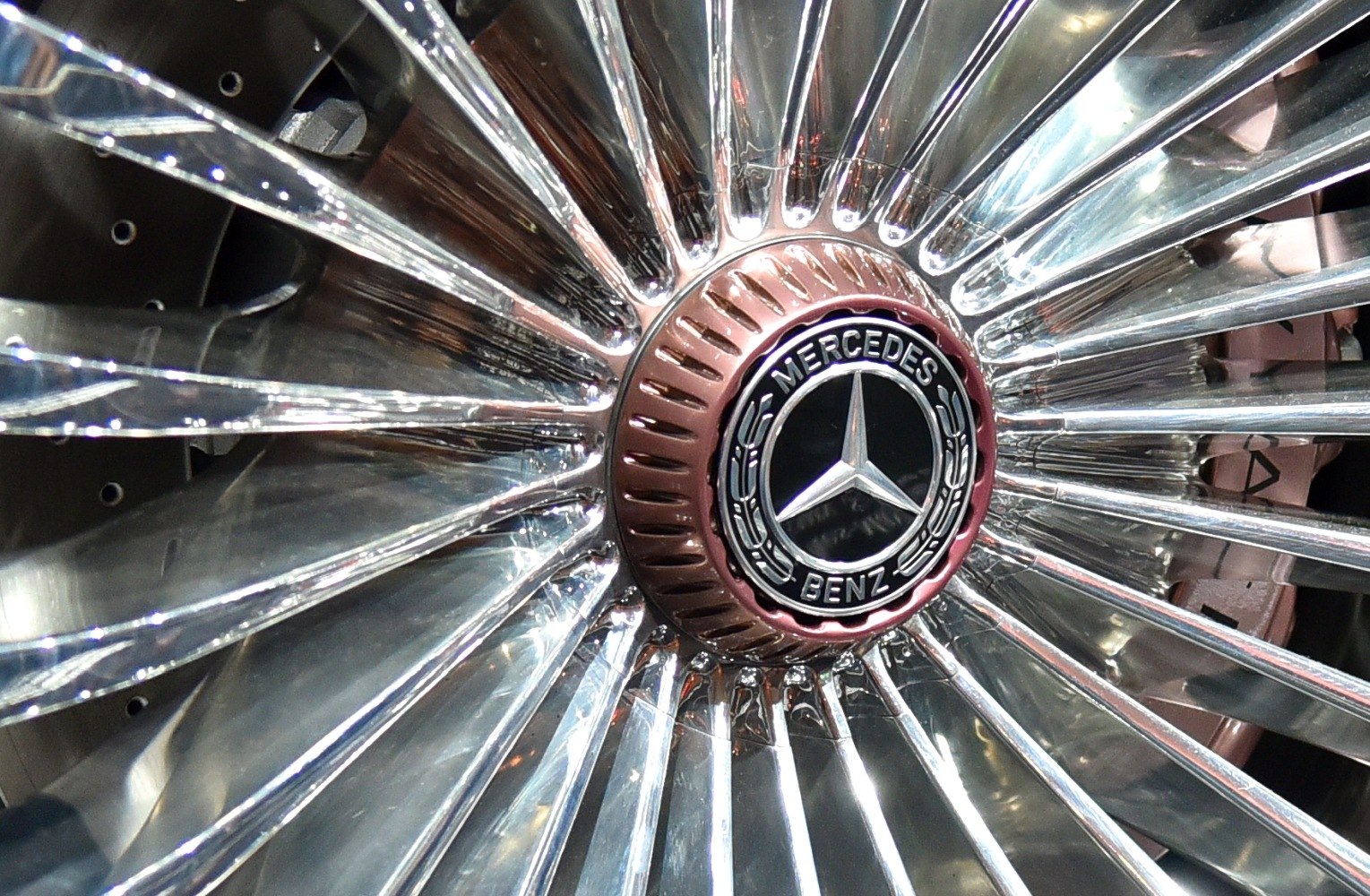 Close-up of a chrome wheel with a Mercedes-Benz emblem hub.