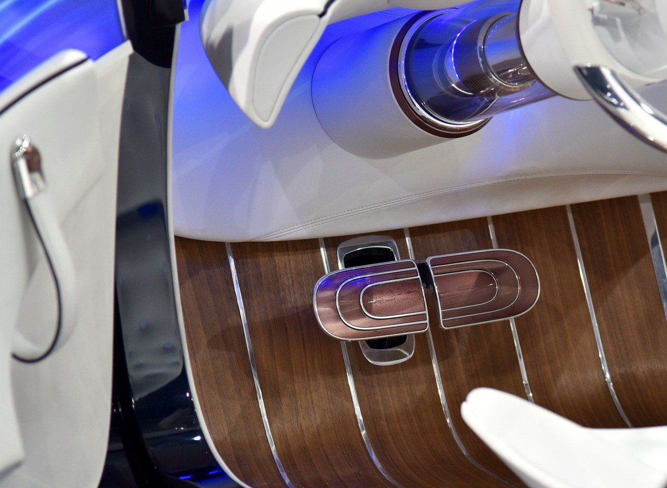 Wood floor with chrome-accented pedals in white leather interior