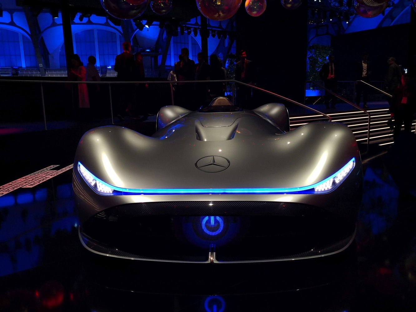 Futuristic silver electric concept with blue LED strip headlights and aerodynamic shape