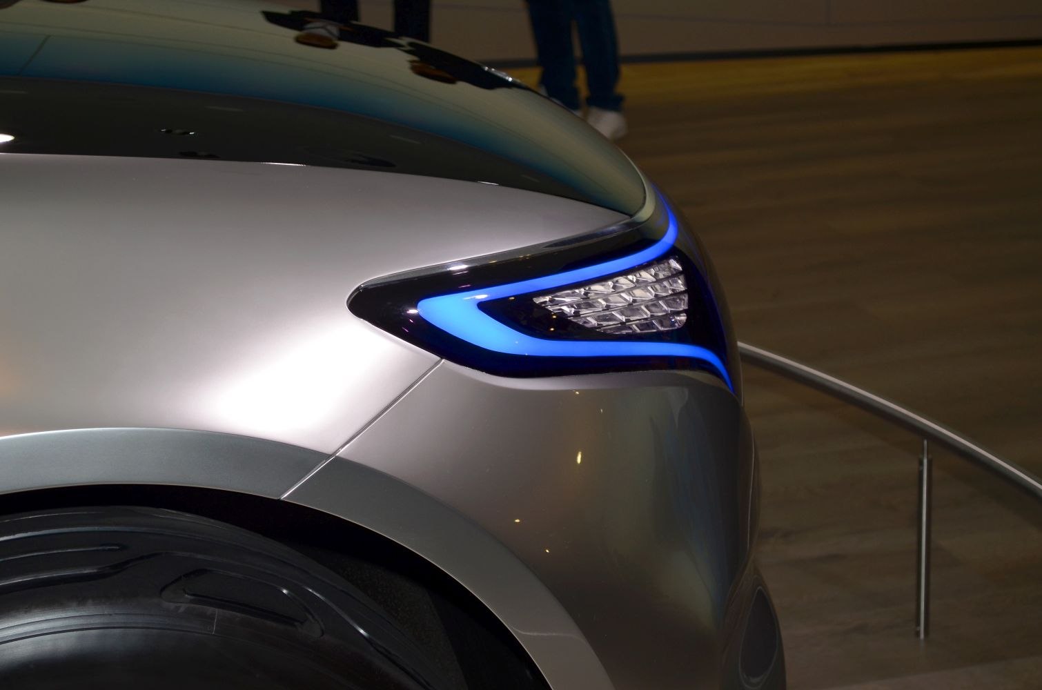 Sleek LED headlight with blue accent lighting on a concept vehicle front fender