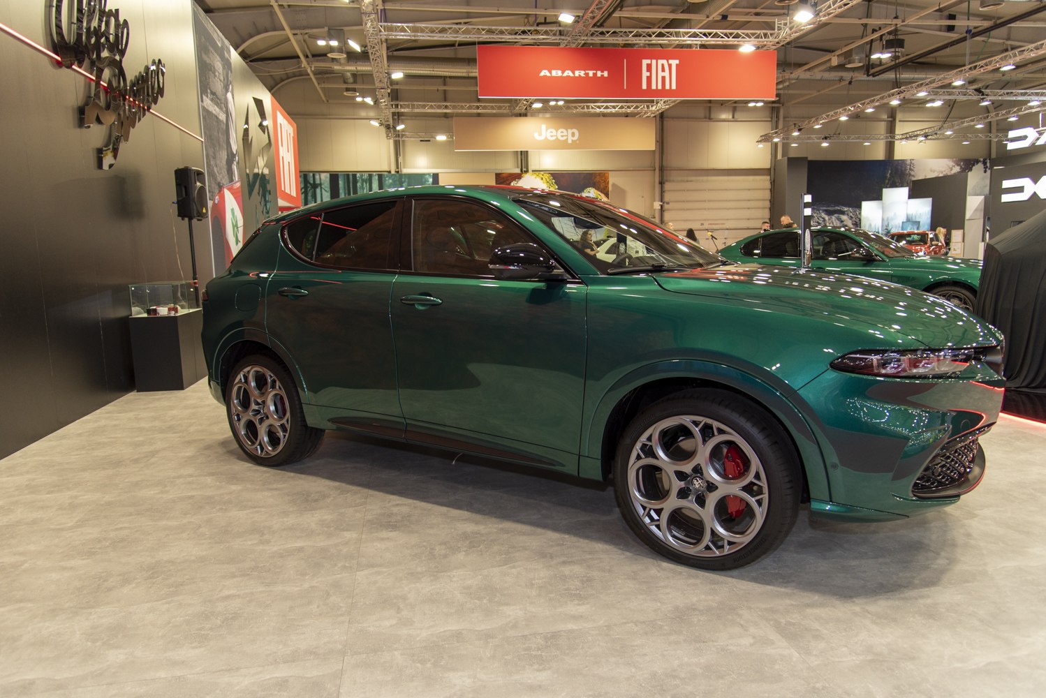 Green SUV with distinct five-spoke alloy wheels and tinted windows