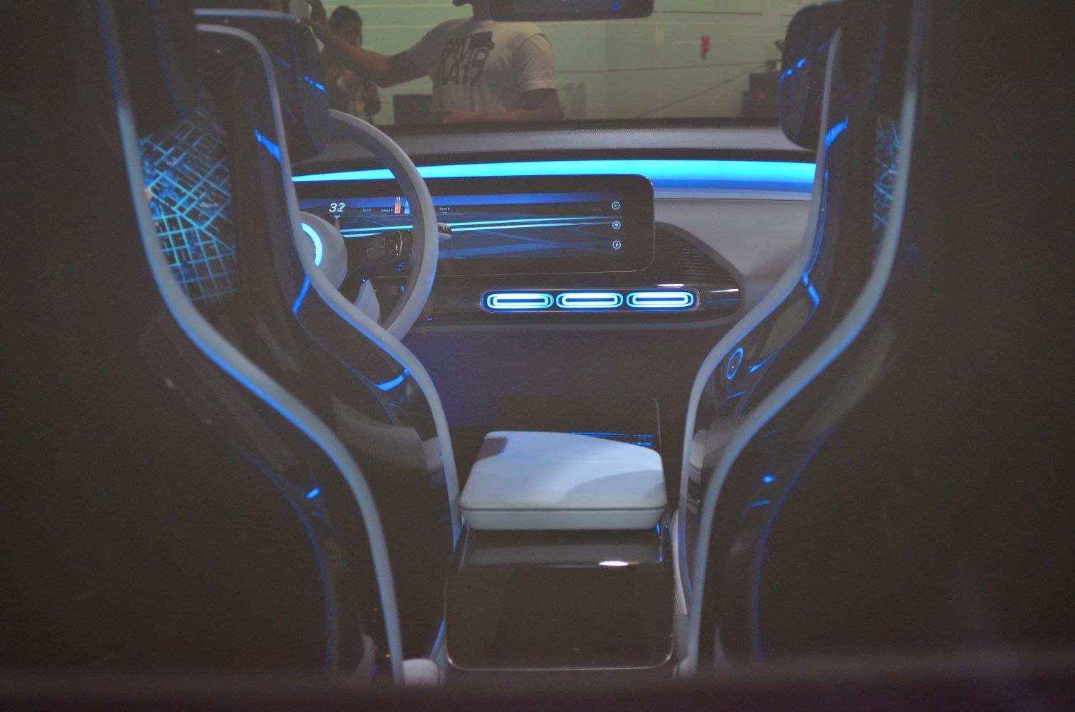 Digital dashboard with ambient blue lighting and futuristic seats