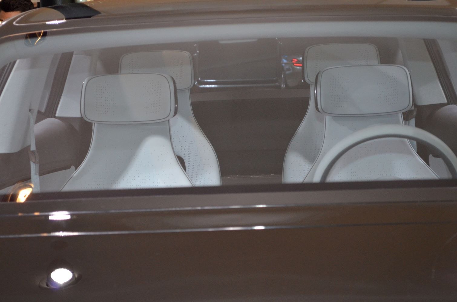 Modern white front seats and steering wheel of a car interior