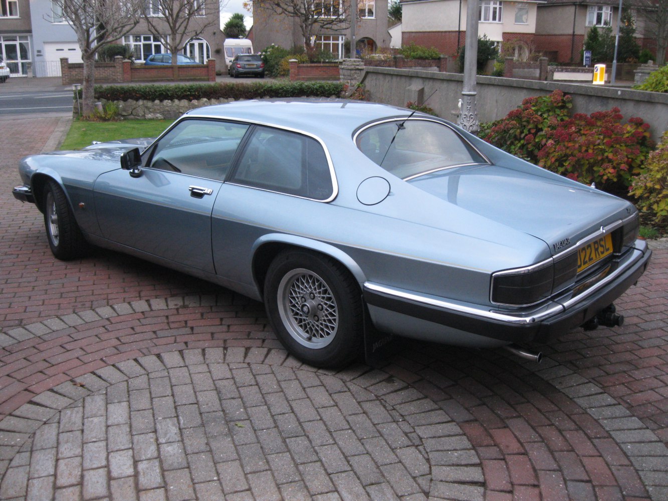 Rear-side view of classic coupe with wire wheels and sleek design