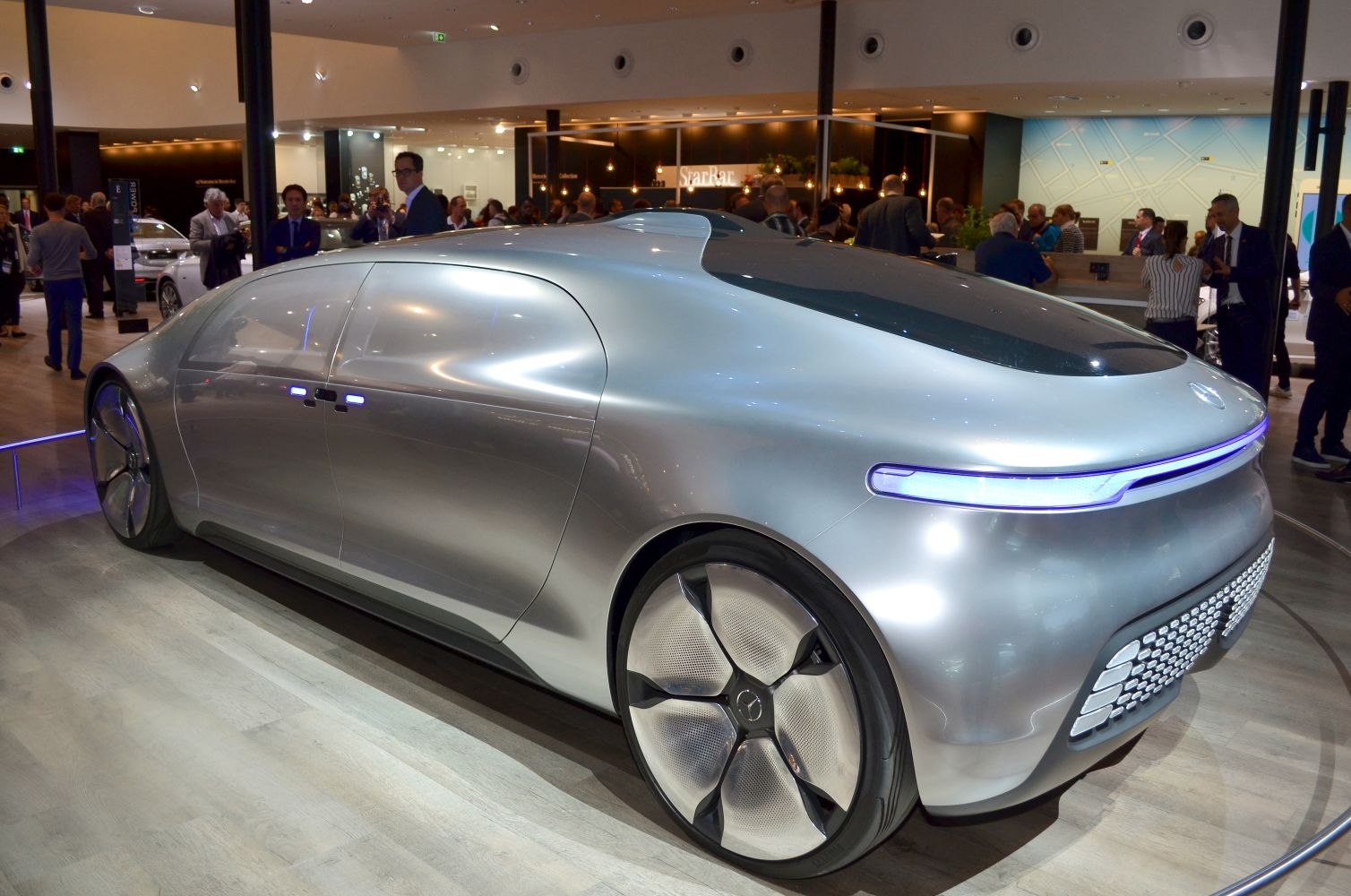 Futuristic electric sedan with sleek smooth body and illuminated rear light strip