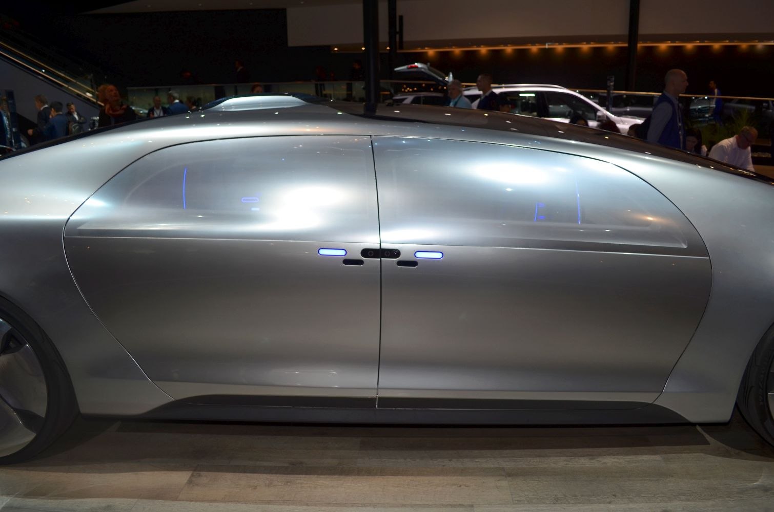 Futuristic car side doors with sleek, smooth design and illuminated handle elements.