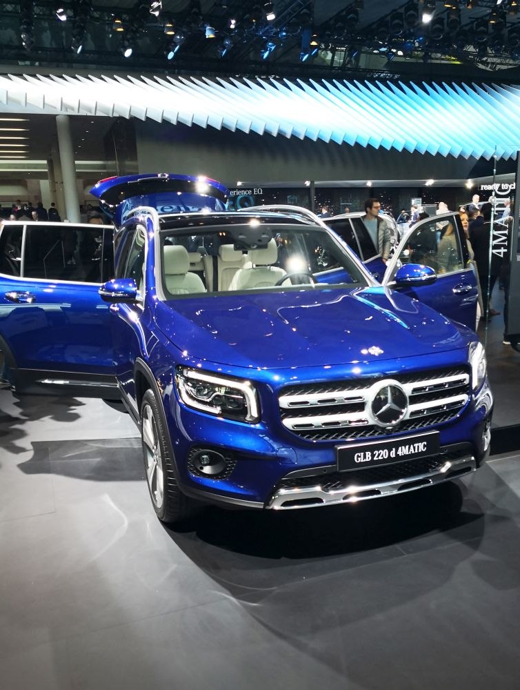 Blue SUV with open doors and prominent front grille.