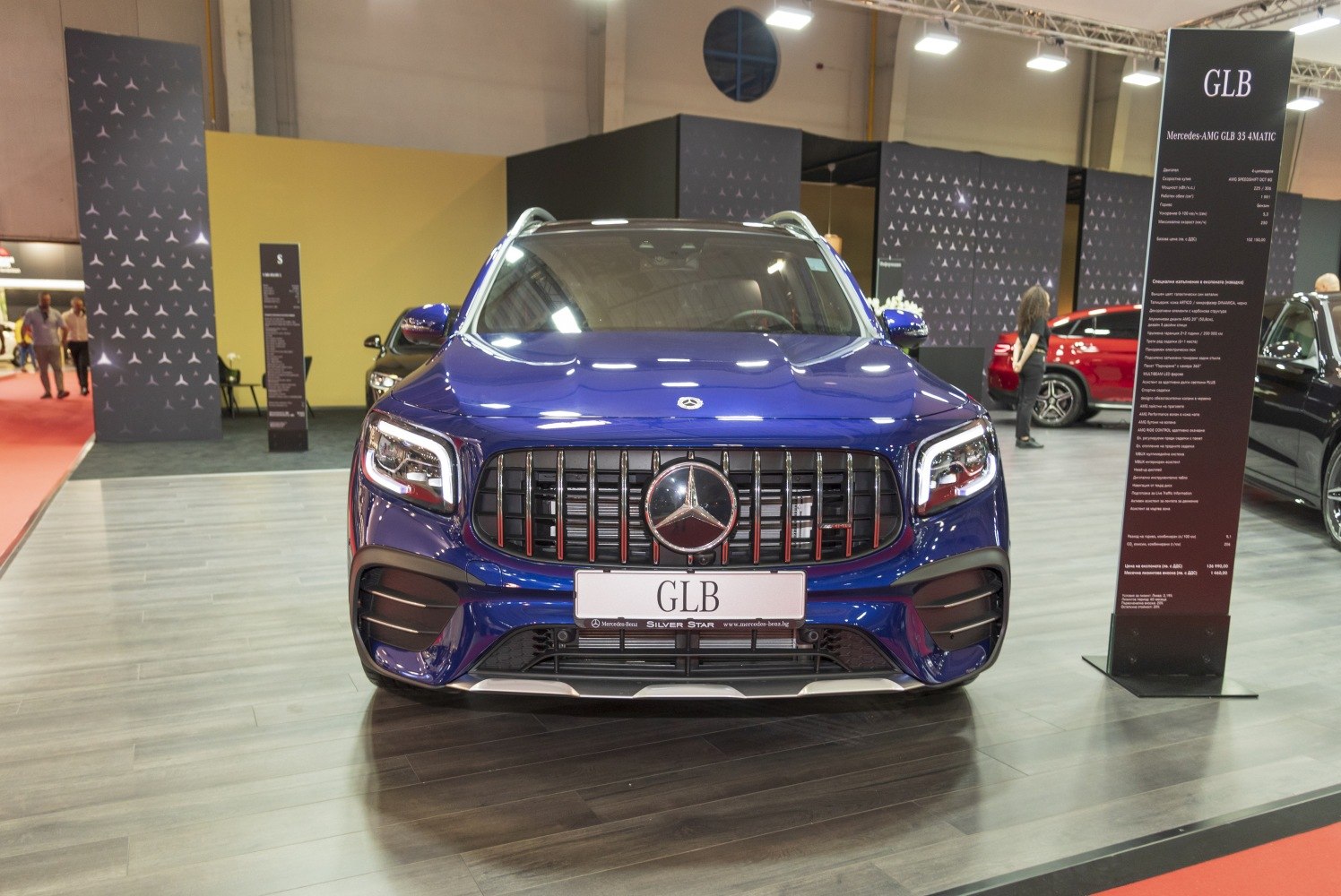 Modern SUV front with vertical black grille bars and angular LED headlights