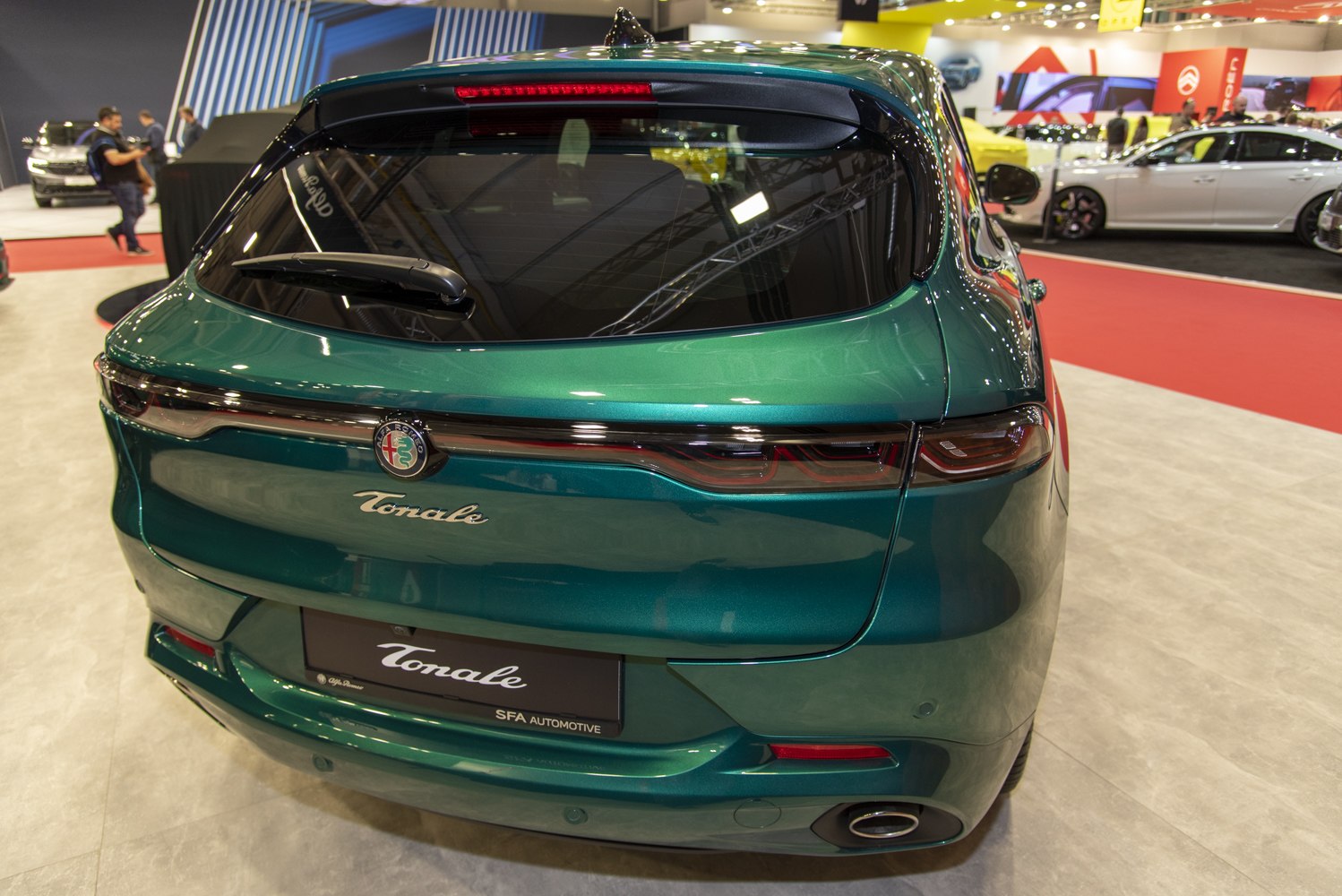 Rear view of green SUV with sleek taillights and single exhaust