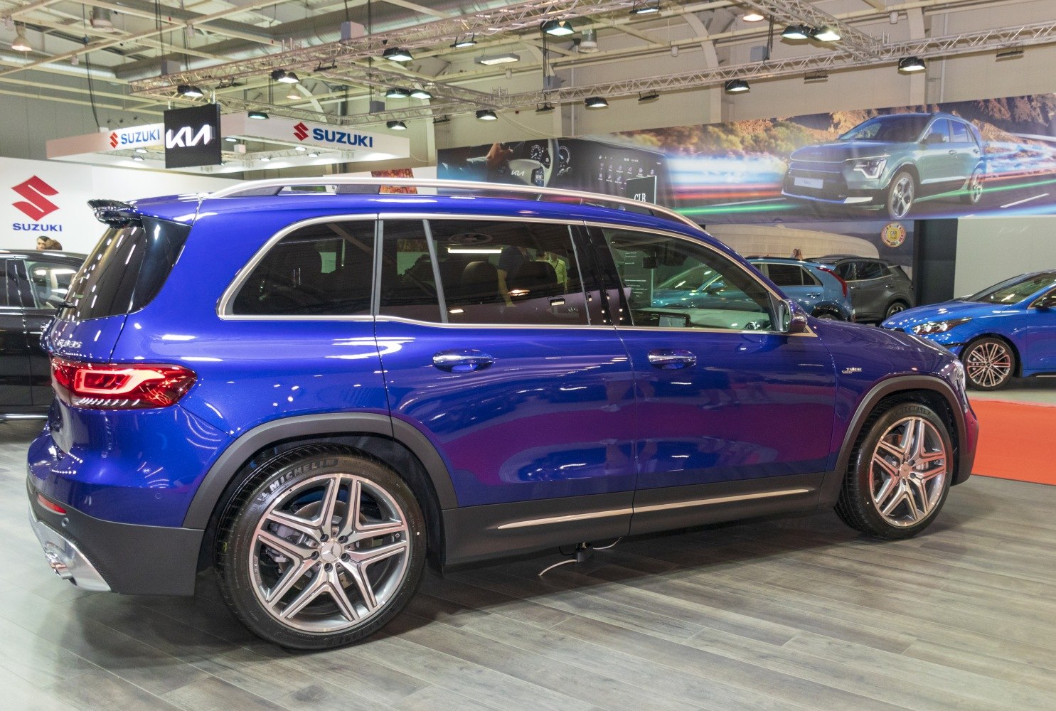 Side profile of blue SUV with alloy wheels