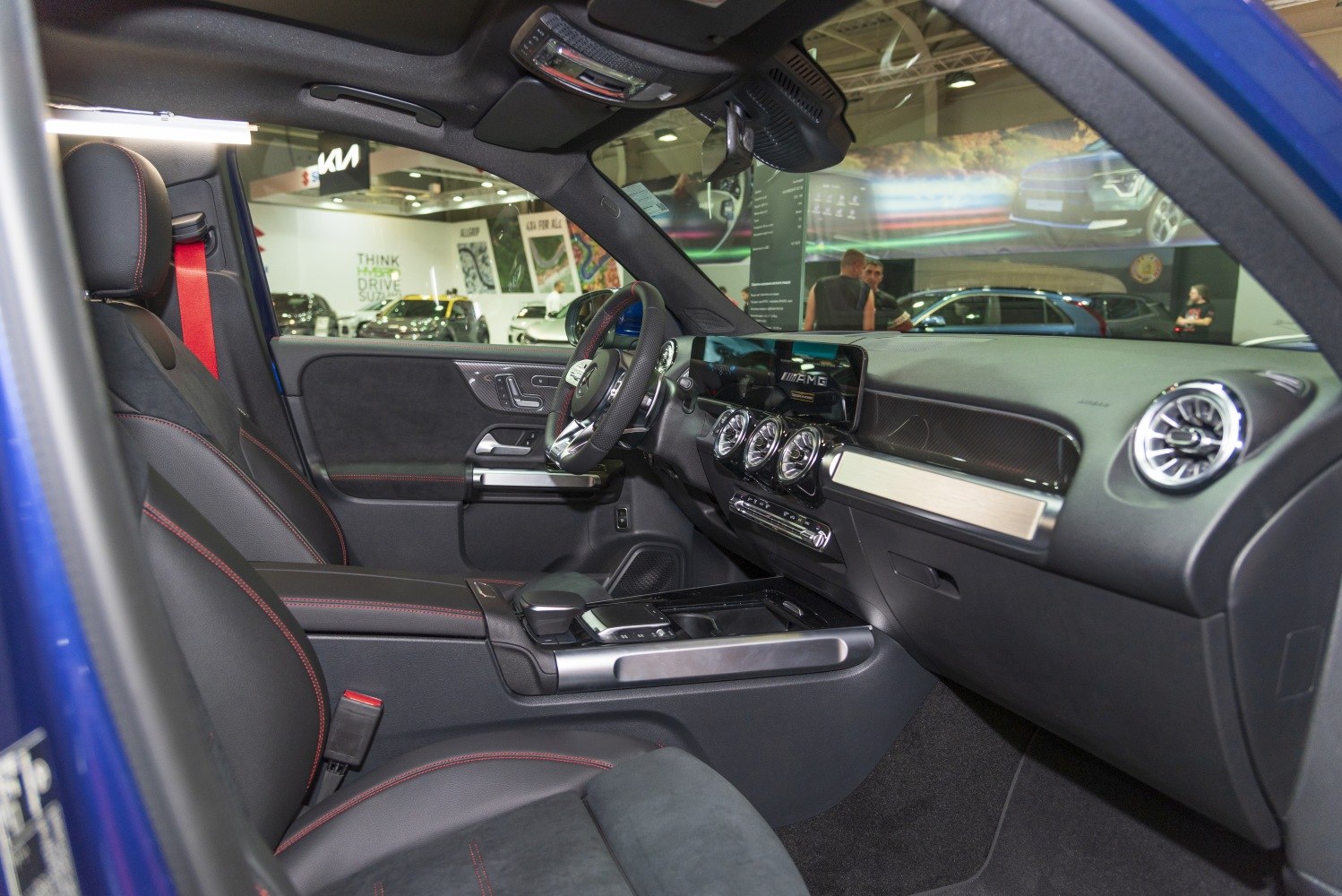 Modern AMG dashboard and premium leather seating with red stitching
