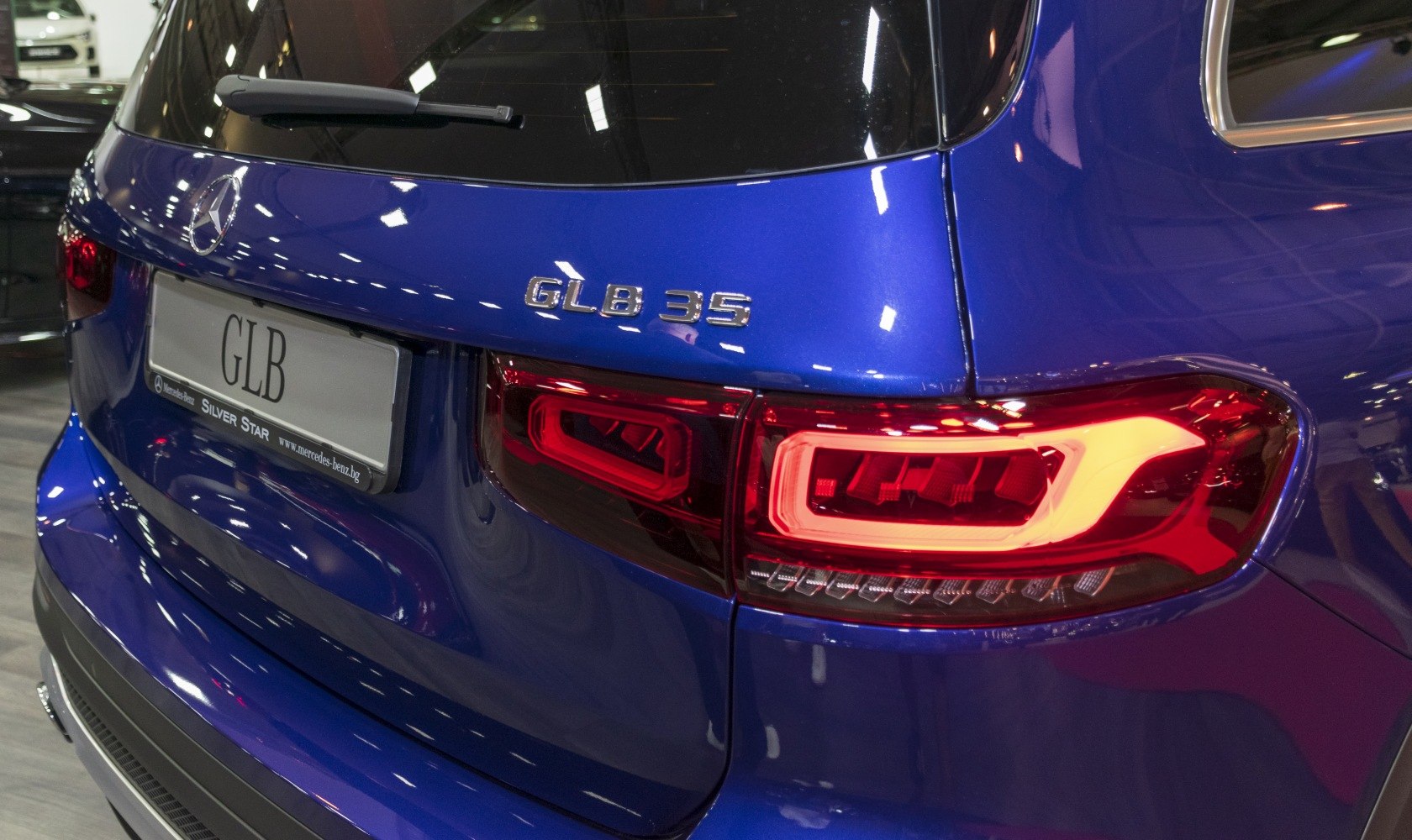 Rear close-up of blue SUV with LED tail lights and model badge