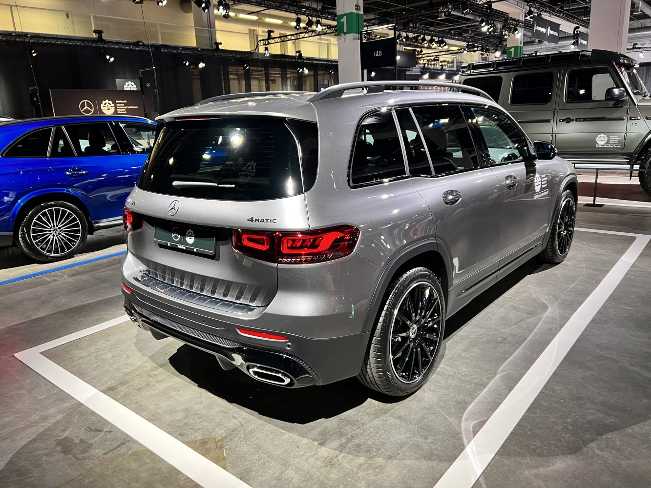 Rear view of a silver SUV with black wheels and distinctive LED taillights.