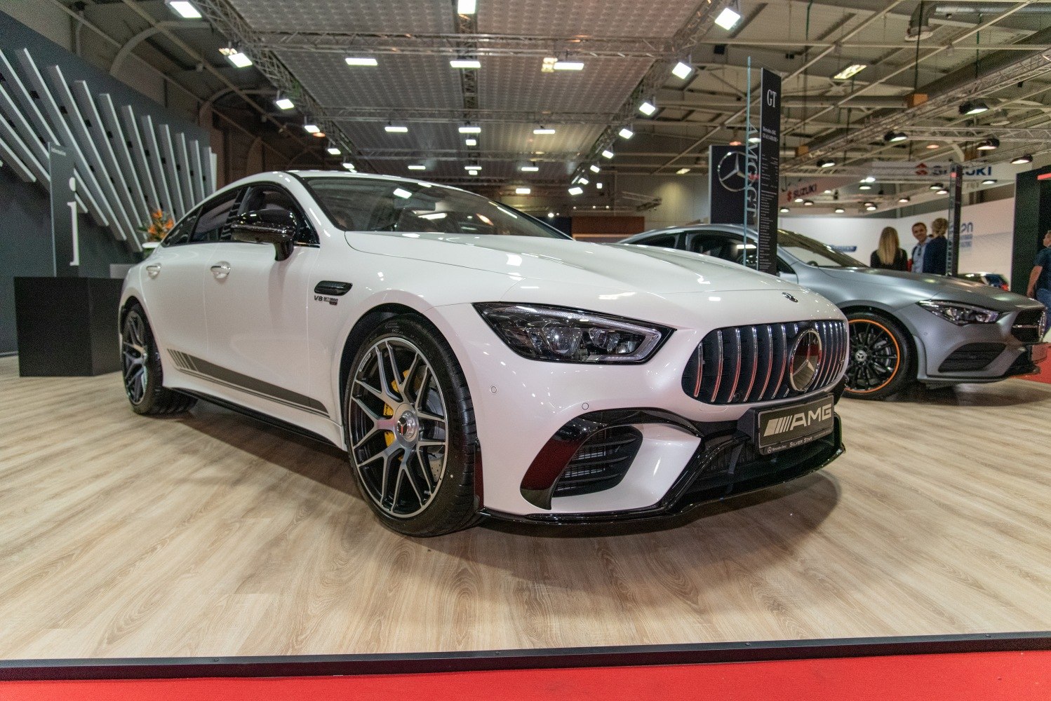 White AMG GT 4-Door Coupe with aggressive grille and V8 badge
